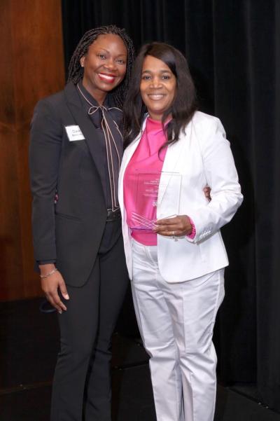 Pebbles Lucas (right) accepts the Child Care Services Association 2024 Mary Y. Bridgers Early Childhood Teacher Award.