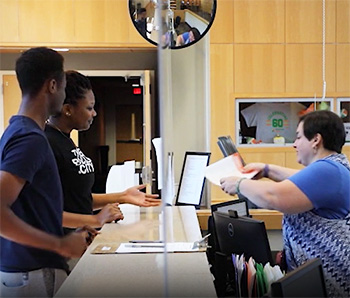Students request assistance at the welcome desk