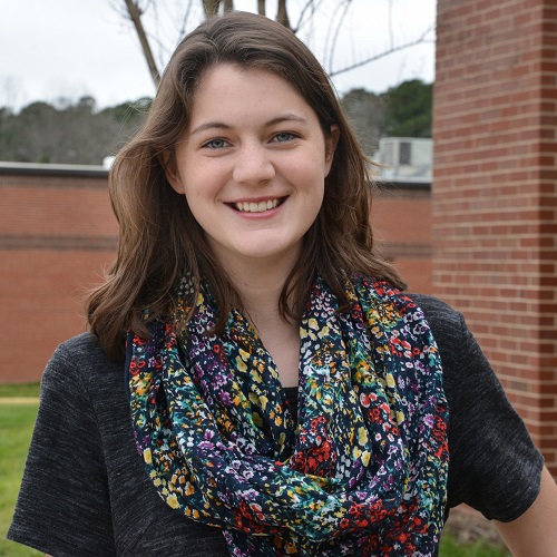 headshot of grace on main campus, wearing scarf