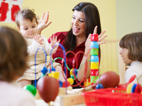 educator playing with toy with toddler