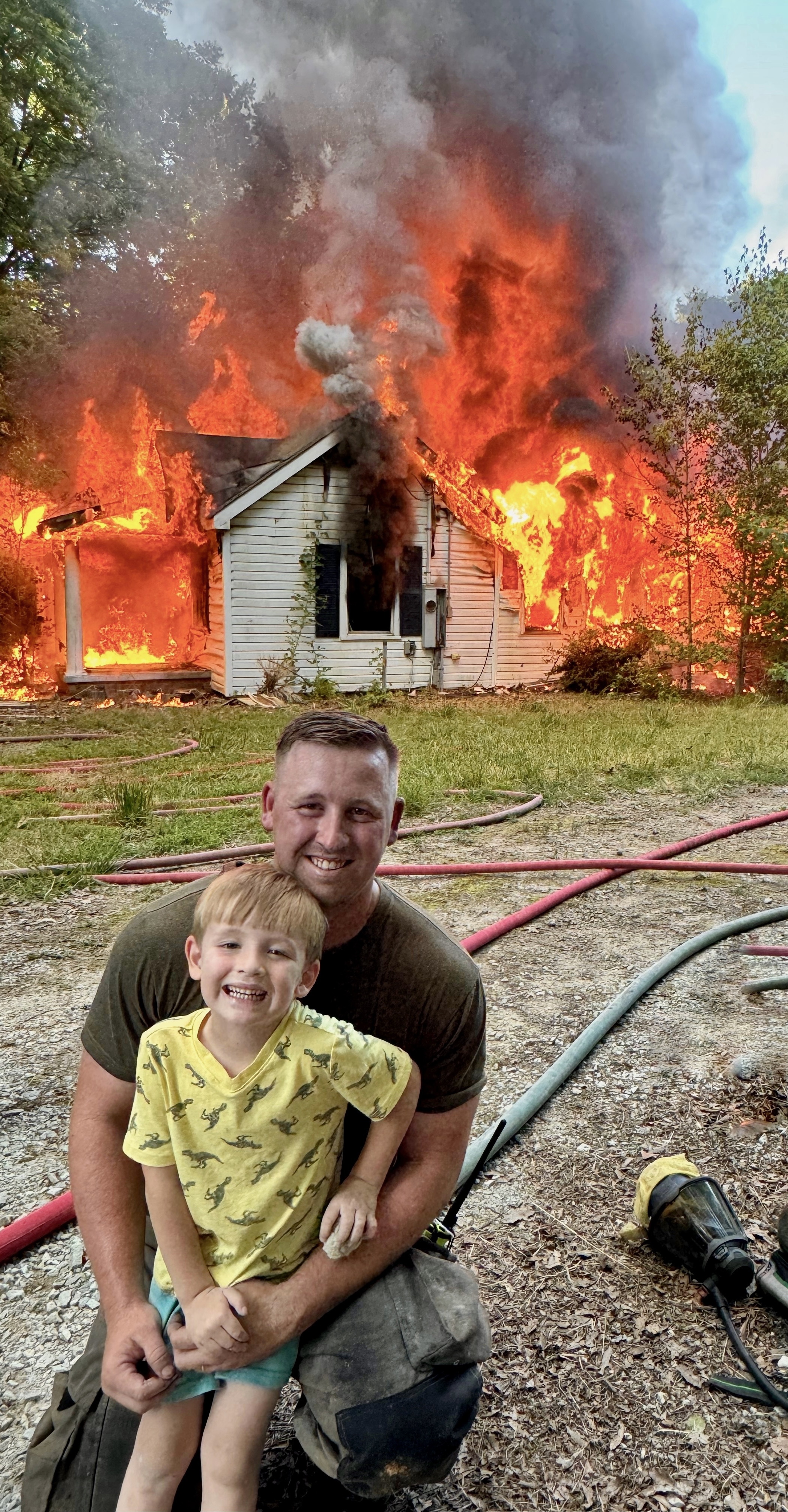 Whitt and his son in front of fire training house