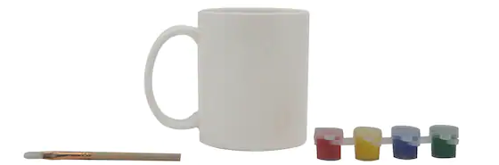 Plain white coffee mug surrounded by paint and brushes