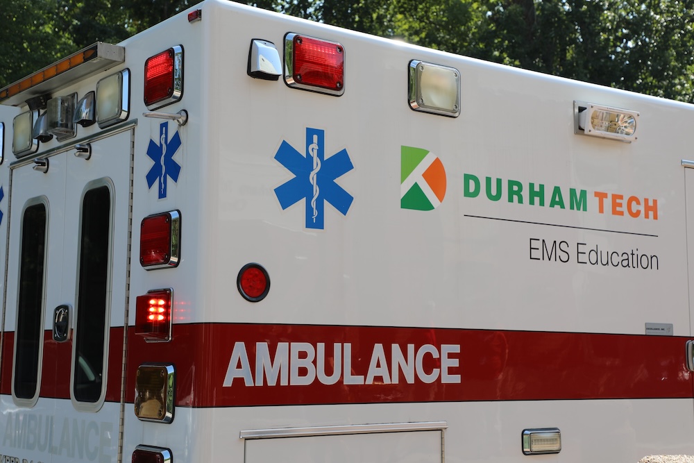 An image of the side and back of a Durham Tech branded ambulance with the words "EMS Education" on the side of it.