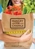A smiling woman holds a paper grocery bag filled with fresh food. The title says, "Hungry for Change."
