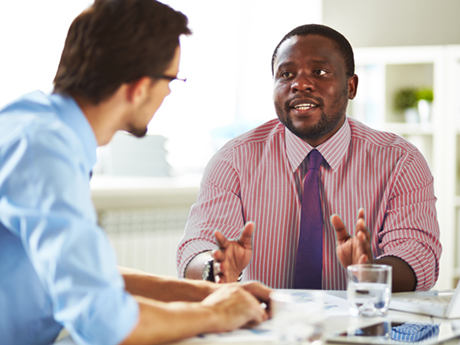 A human resources professional talks to an employee during a meeting.