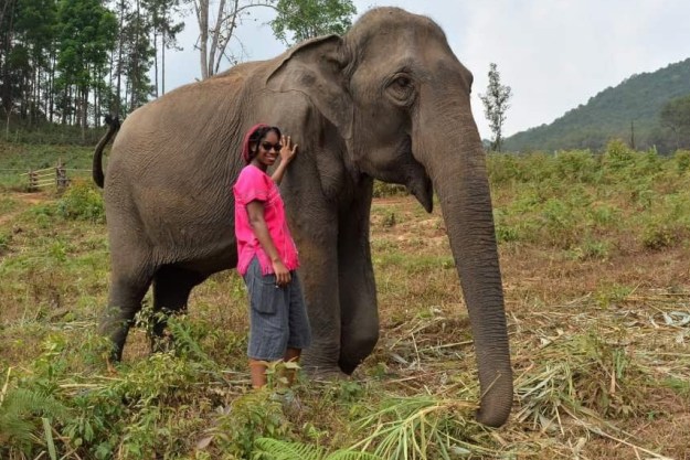 Jonitka poses next to an elephant