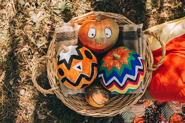 three pumpkins in a basket