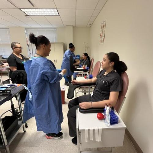 Students practice drawing blood in a phlebotomy class at Durham Tech.